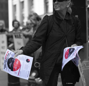 Ruth Benn leafleting with the pie chart on Tax Day in front of the Manhattan IRS in 2015 (photo by Ed Hedemann)