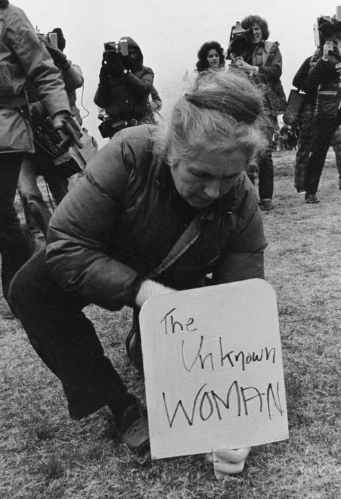 Grace planting a sign for women victims of war, Women’s Pentagon Action, 1980. Photo by Dorothy Marder, WRL Files.